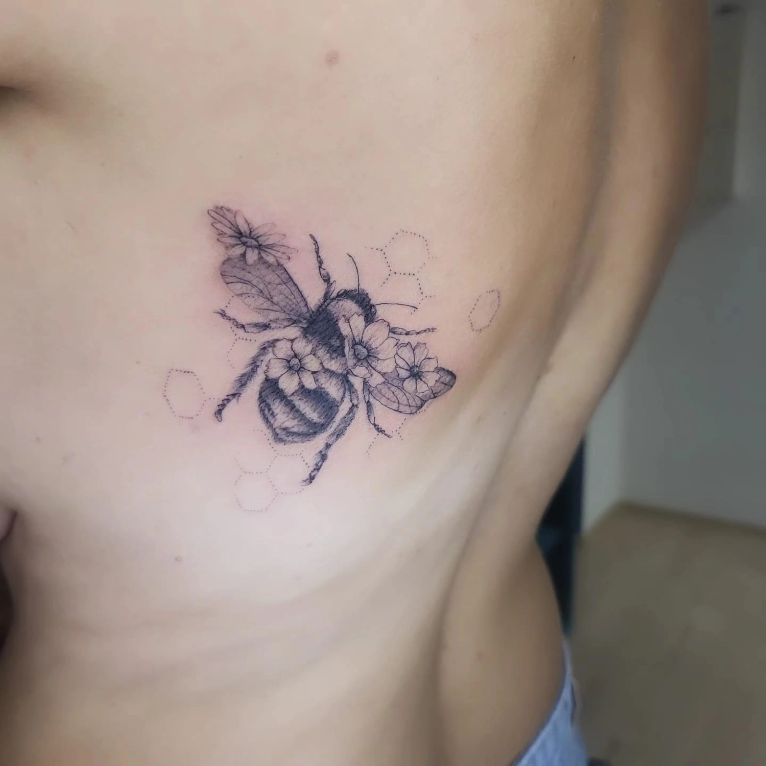 A Fleur de Peau - Professionelles Tattoo Studio - Tätowierung am Bein einer Person